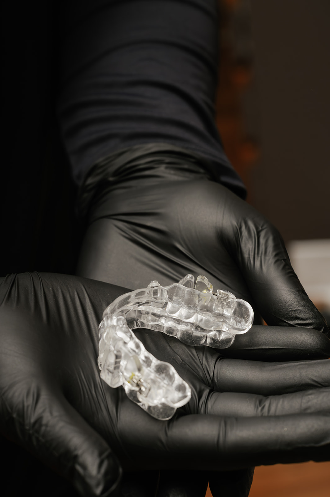 Custom sleep appliance held in gloved hands — Bublik Dental Wausau WI
